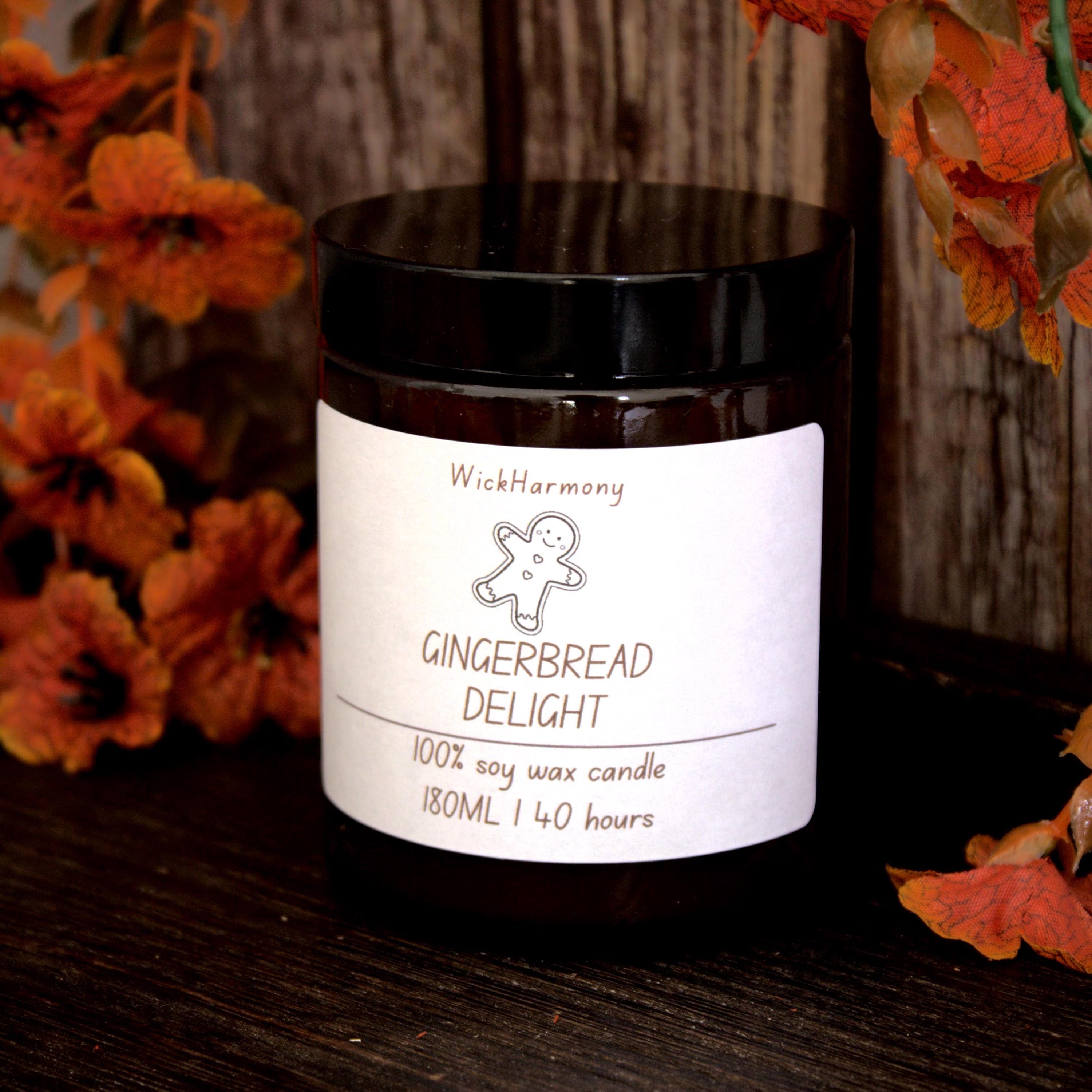 The 'Festive Doodle' personalised soy candle by WickHarmony, styled in a cosy autumn setting against a dark wood background