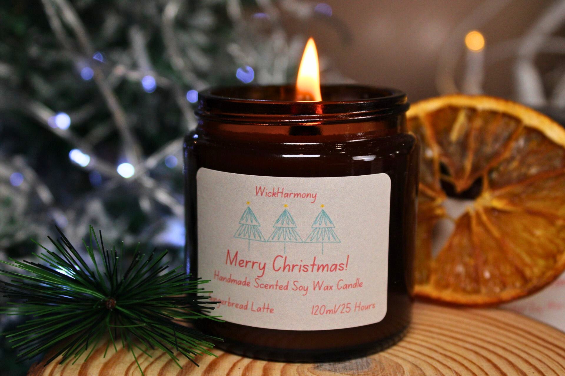 A lit medium 120ml soy candle with a crackling wick and a simple Christmas tree label, creating a warm, festive glow.
