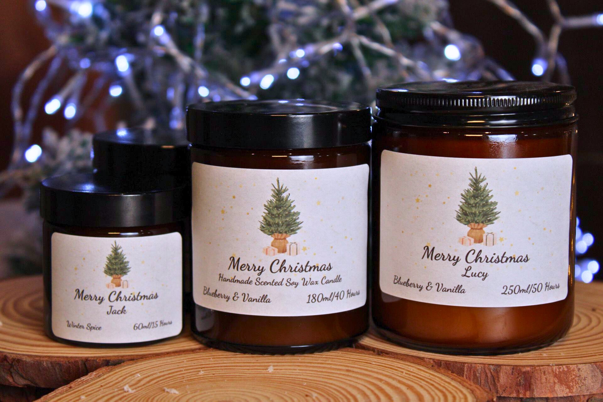 Three different sizes of personalised Christmas tree candles displayed together to show the product range