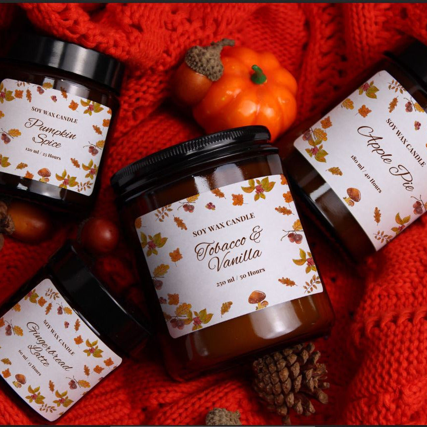 Flatlay of the WickHarmony 'The Woodland Walk' candle collection, showing four artisan soy candles on a cosy red jumper.