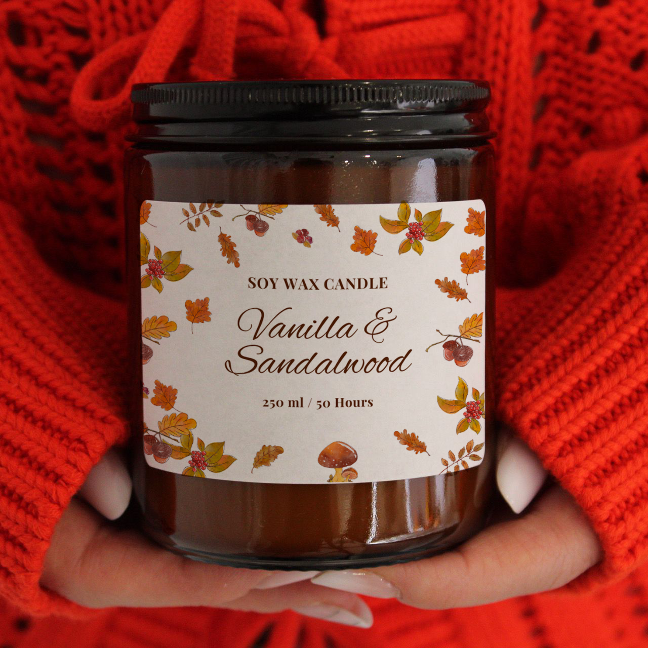 Close-up of 'The Woodland Walk' soy candle with crackling wooden wick, held by a person wearing a cosy red jumper.