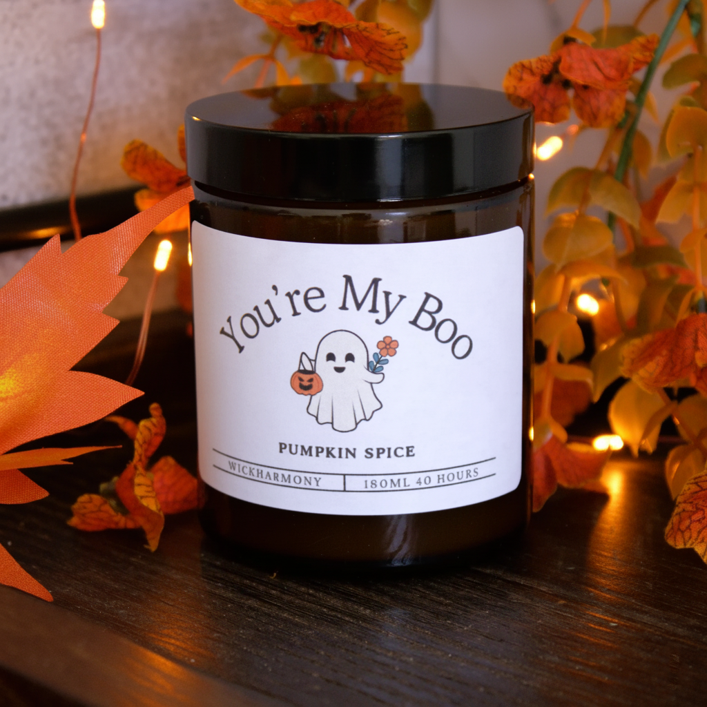 The 'You're My Boo' cute ghost candle by WickHarmony, styled with orange autumn leaves and fairy lights